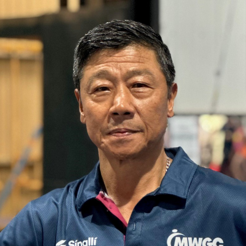 A man wearing a blue shirt that says mwcc on it