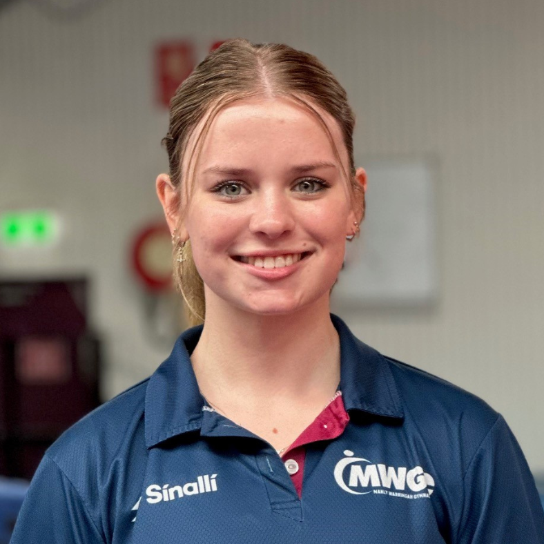A woman wearing a blue shirt with the word mwg on it