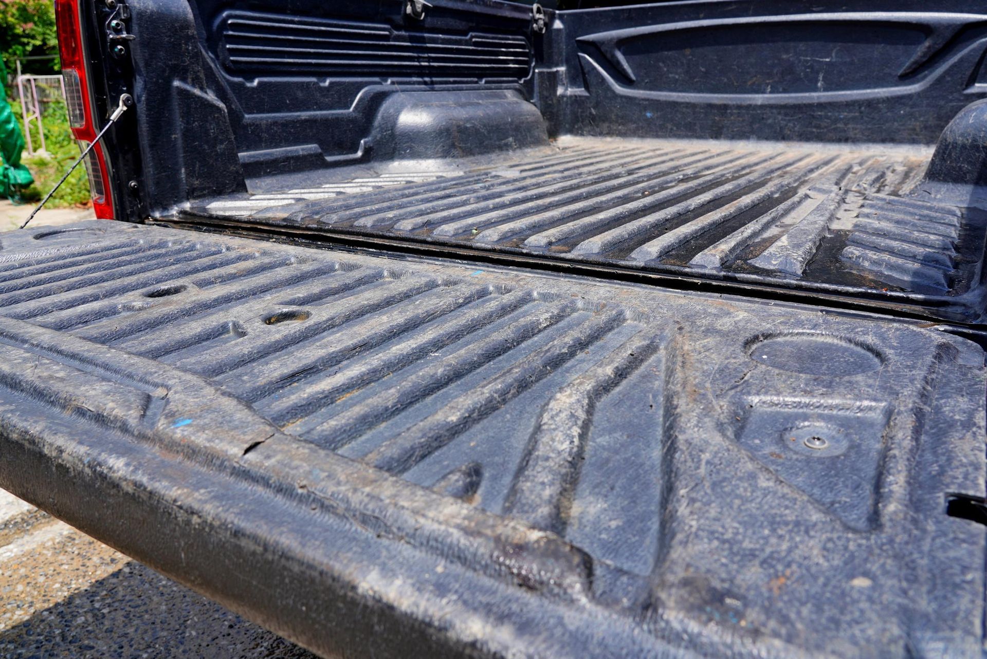 Close-up of a black pick-up truck’s plastic floor liner.