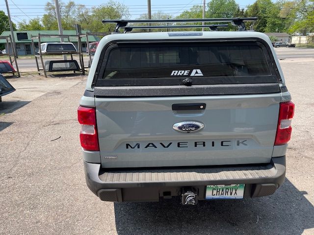 Rear view of a gray Ford Maverick truck with a camper shell, roof rack, and 