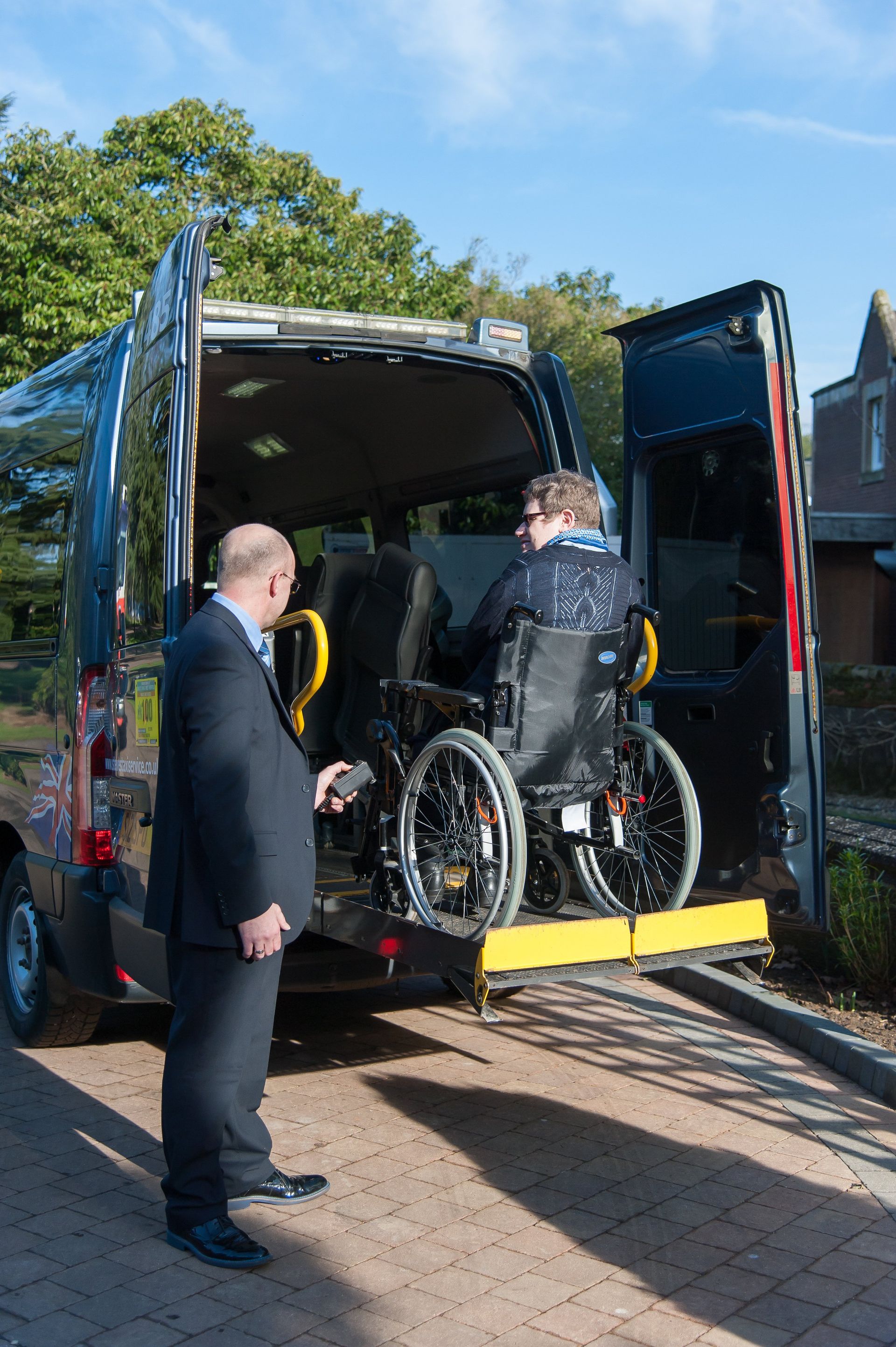 wheelchair being loaded into minibus