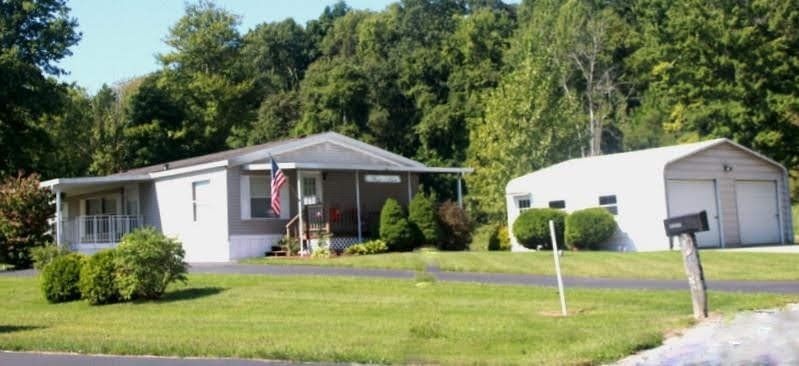 White House with American Flag — Byesville, OH — Country Court Mobile Home Park