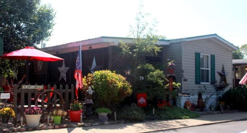 House with Signage and American Flag Outside — Byesville, OH — Country Court Mobile Home Park