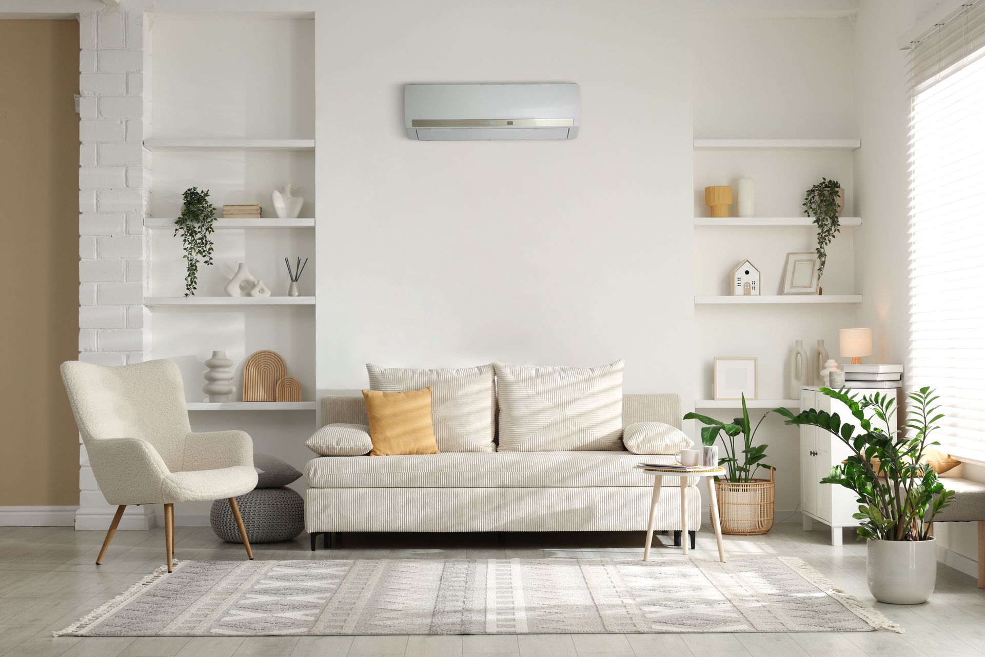 A ductless air conditioner is mounted on the wall of a modern living room.