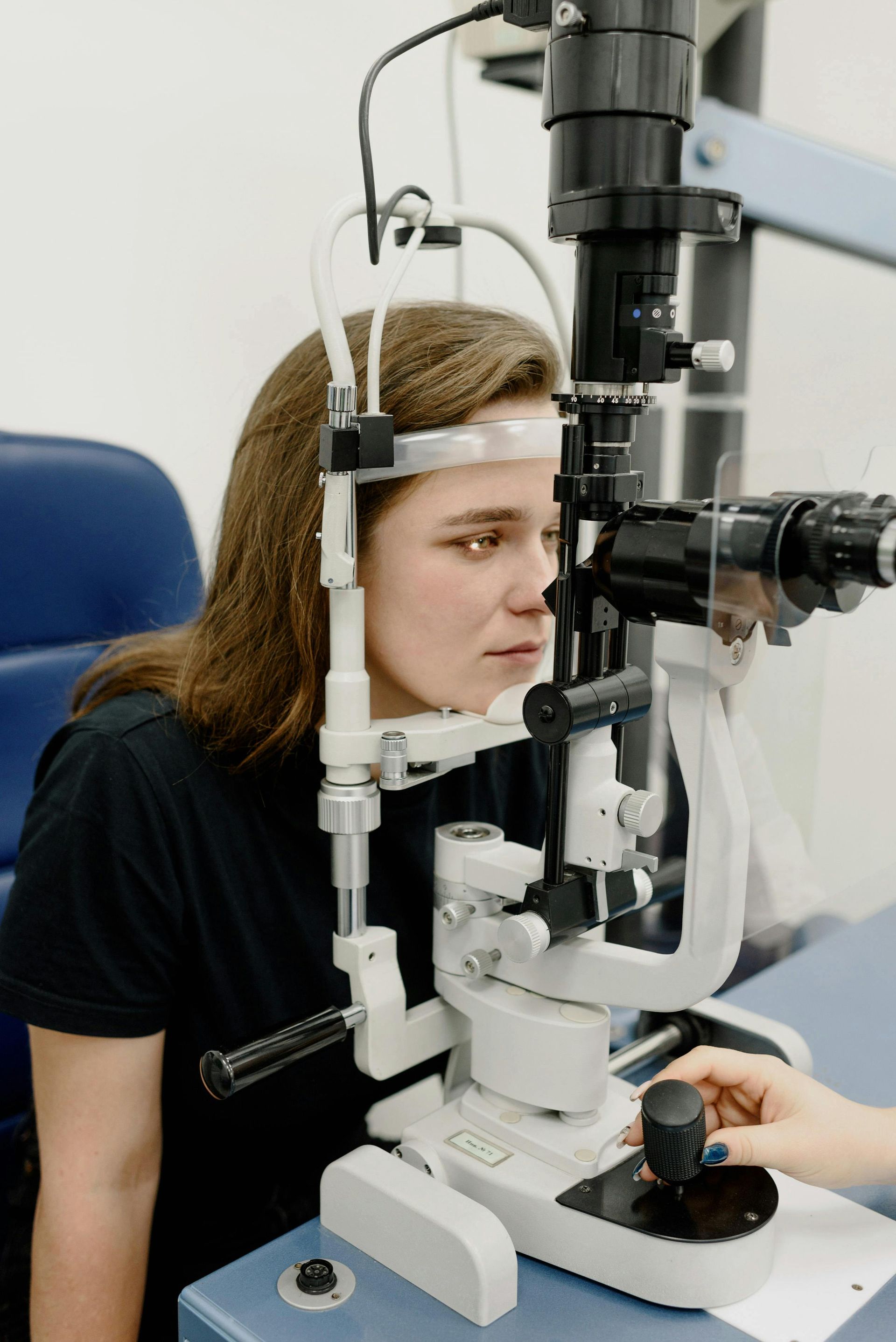 A person with a cast on their foot is sitting in a wheelchair.