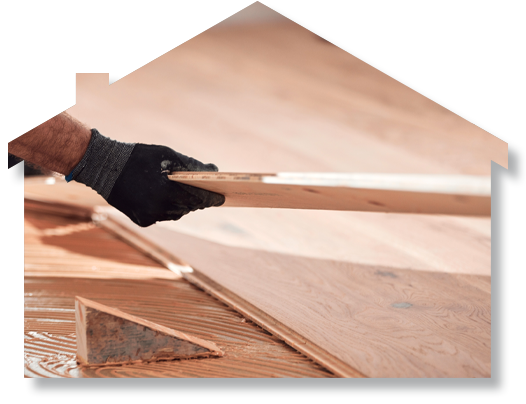 A person is holding a piece of wood in their hand.