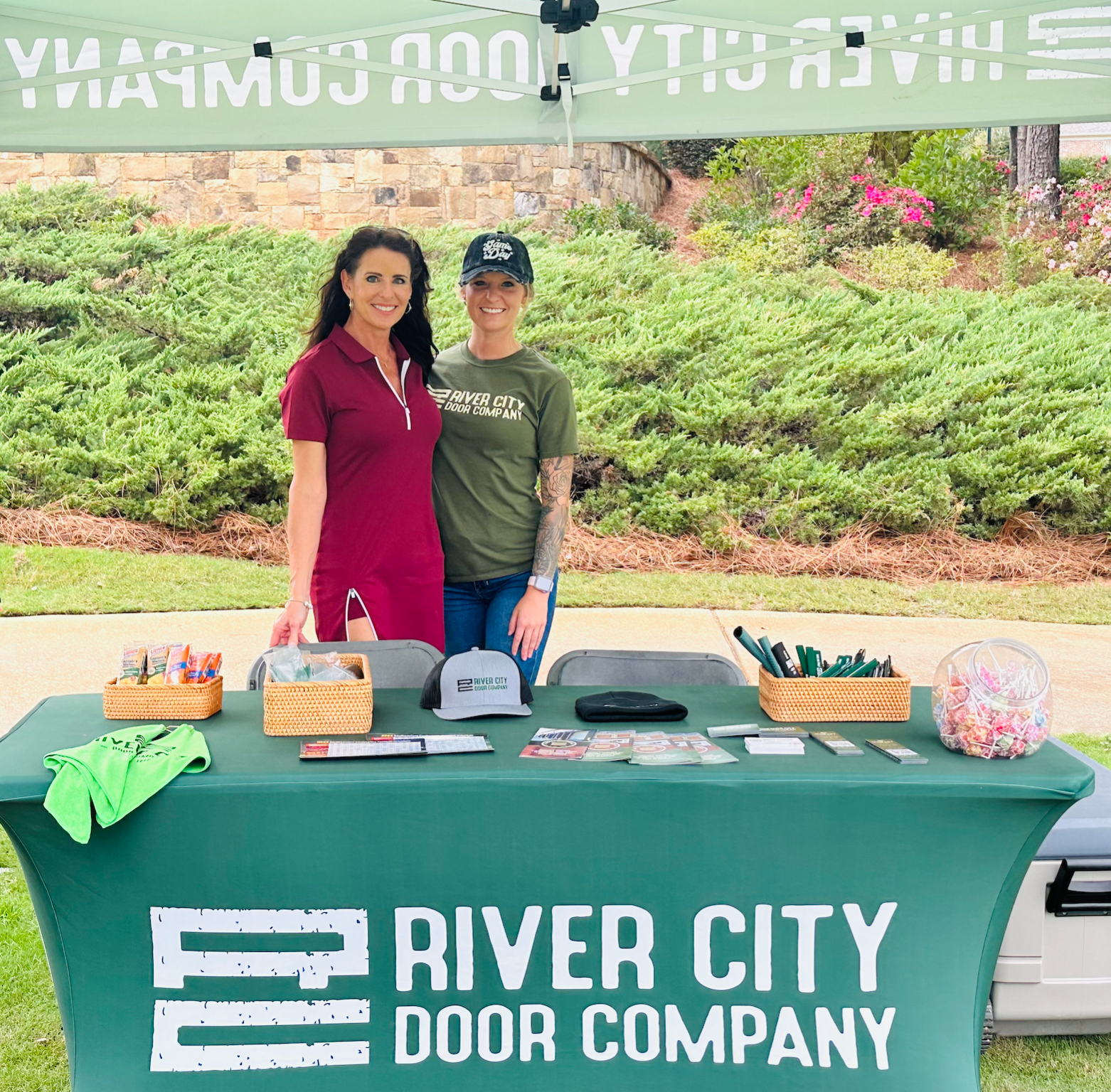 Woman working on laptop, analyzing charts and using a calculator at a desk in a sunny office.