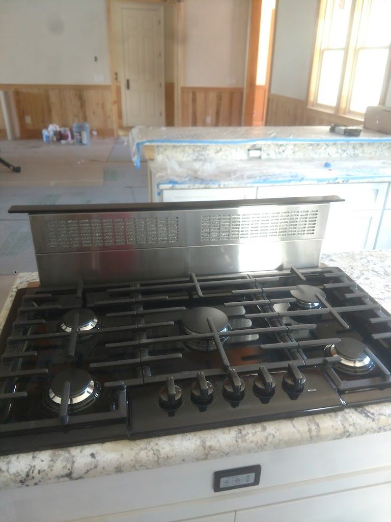A stove top oven is sitting on top of a counter in a kitchen.