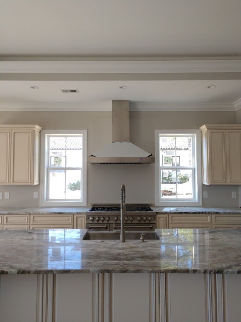 A kitchen with a stove top oven and a sink