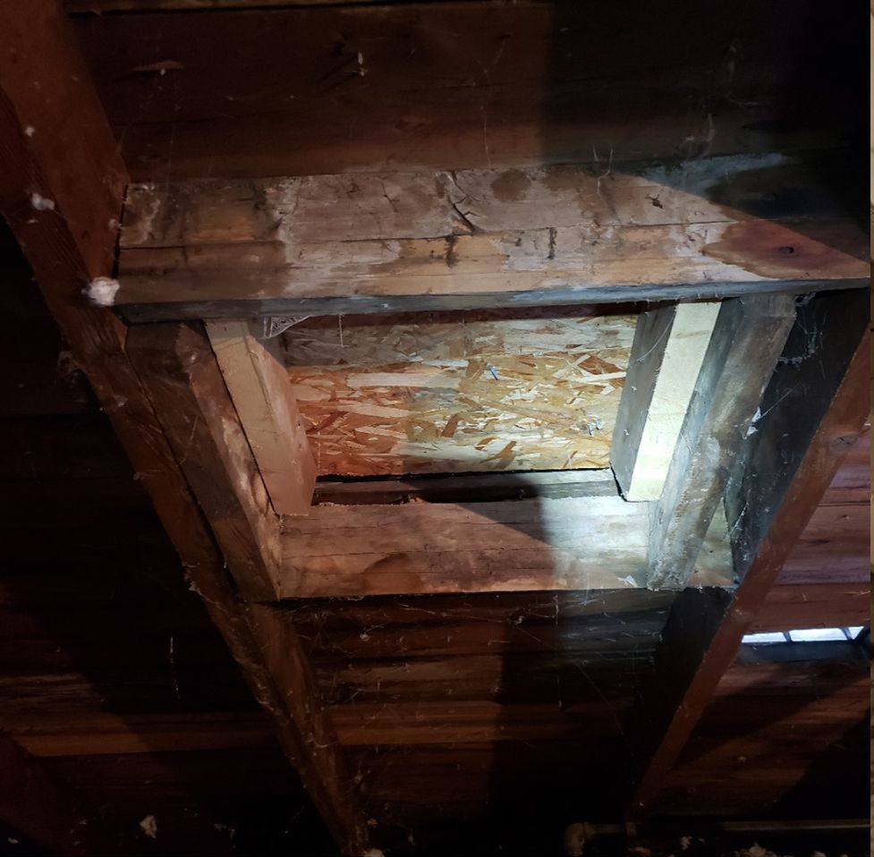 There is a hole in the ceiling of a building.