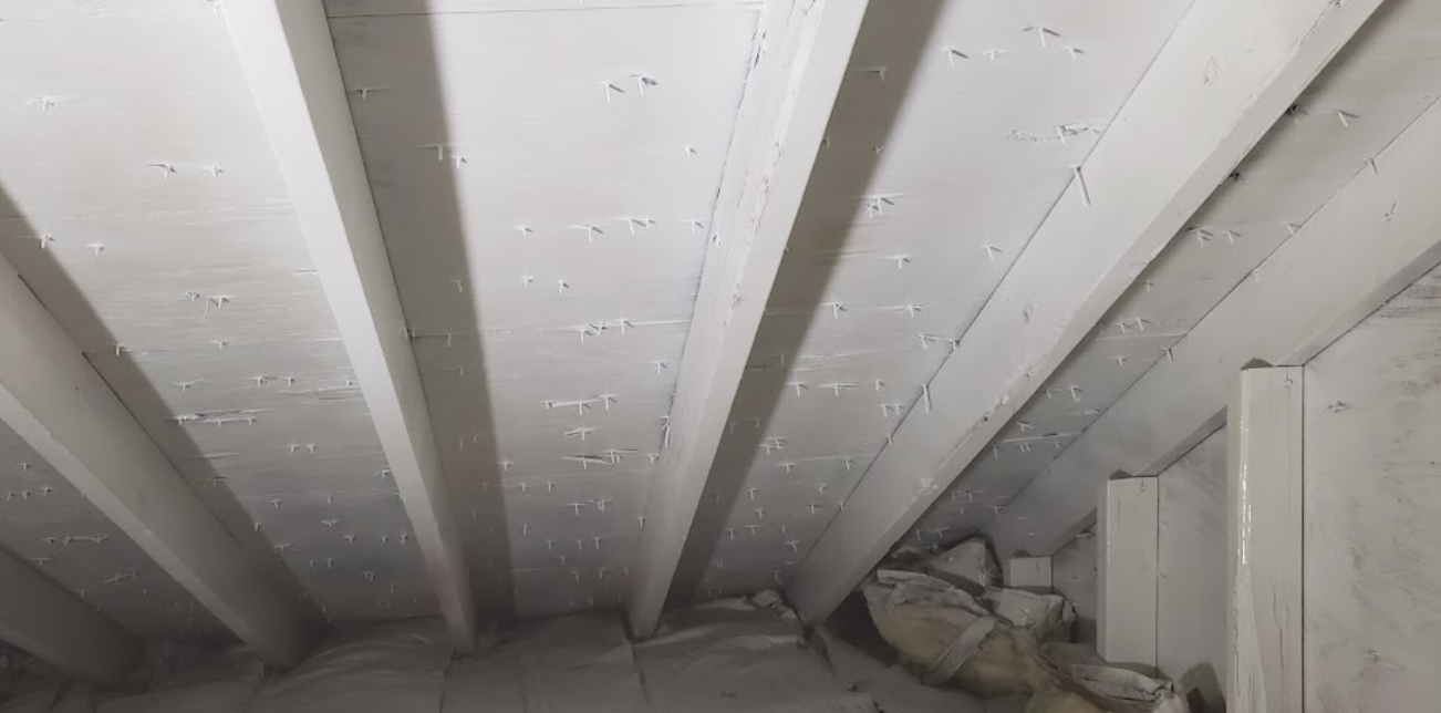 A close up of a white ceiling in a room.