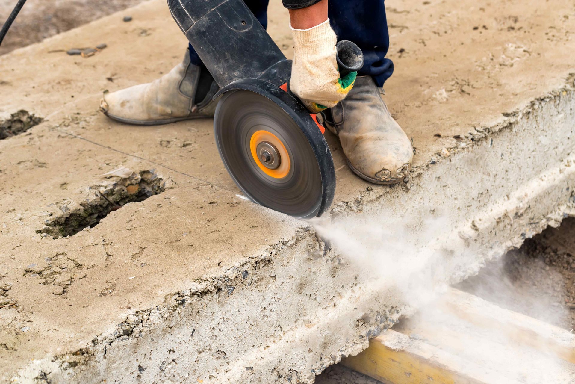Technician Cuts Piece Of Concrete With Circular Saw