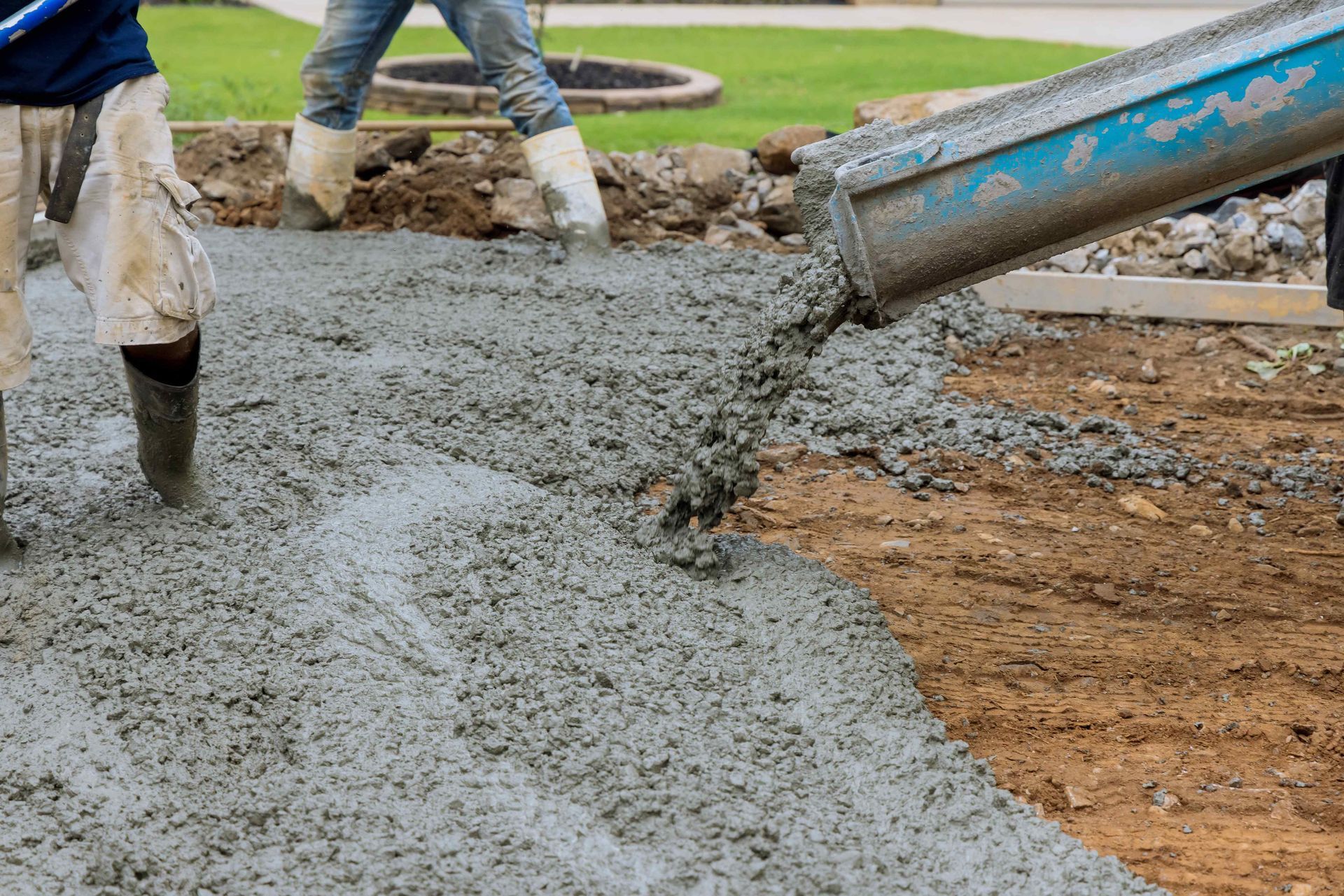 Technicians Pouring Concrete For New Driveway Of Home