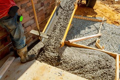 Expert Technicians Pouring Concrete For Sidewalk To House