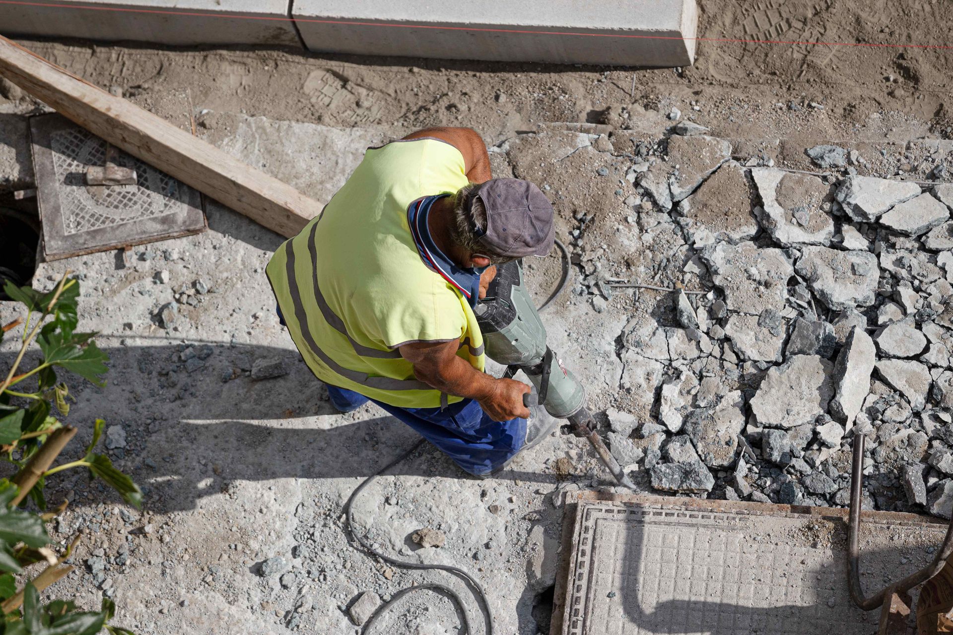 Worker With Jackhammer Drilling Broken Concrete For Removal And Repair