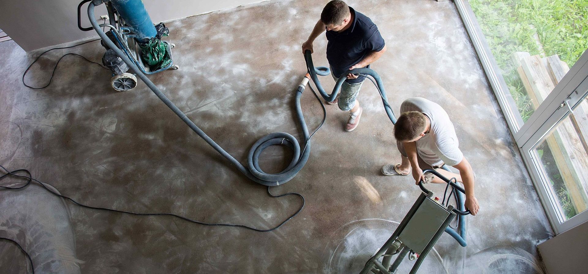 Workers Polishing Concrete Floor In House