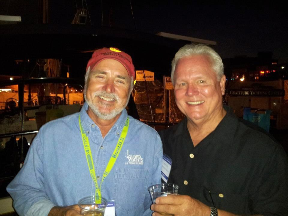 Two men standing next to each other with one wearing a lanyard that says lynx