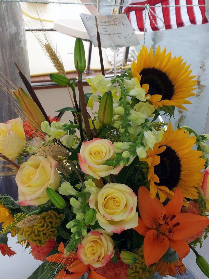 A bouquet of flowers including sunflowers and roses
