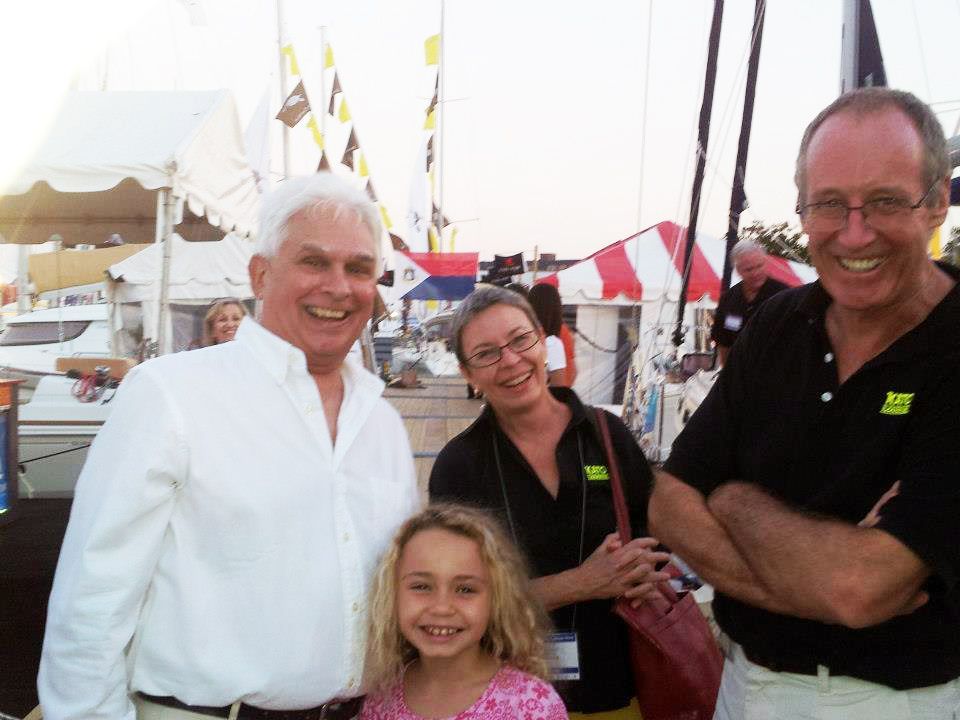 A group of people posing for a picture with one man wearing a cat shirt