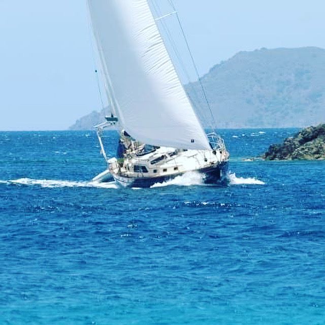 A sailboat is floating on top of a large body of water.