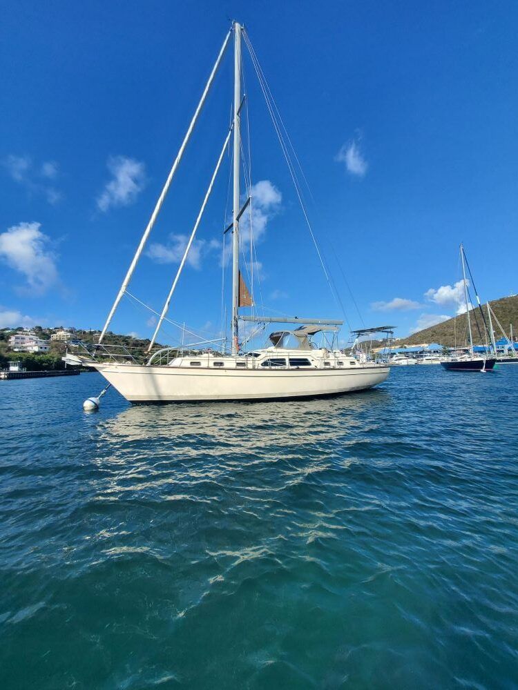 A sailboat is floating on top of a body of water.