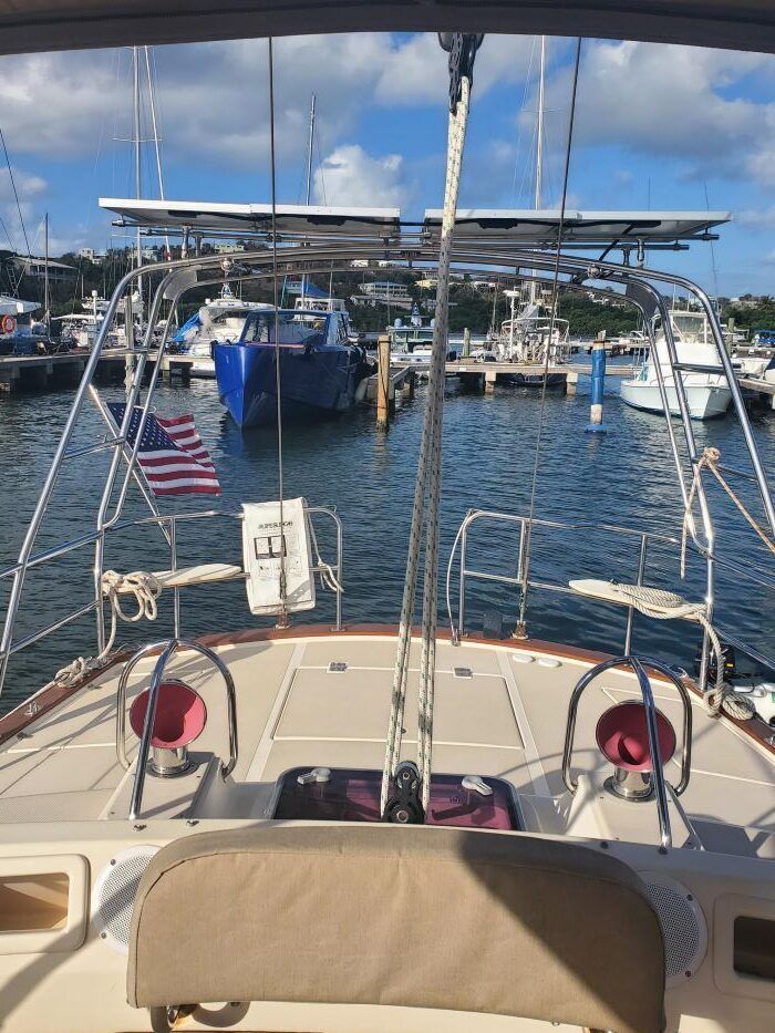 A boat is docked in a harbor with boats in the water.