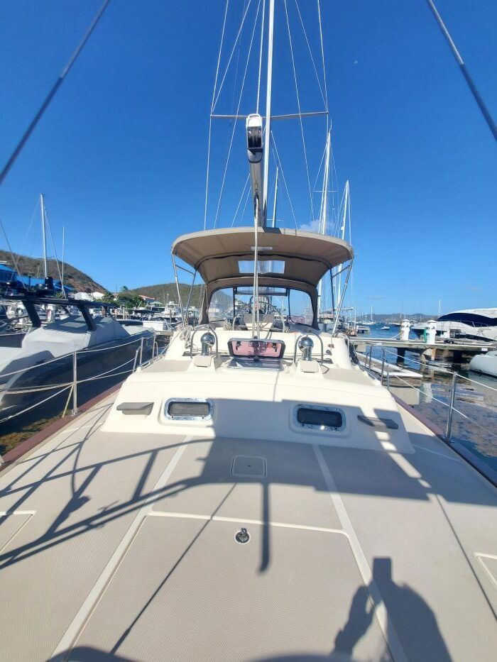 A sailboat is docked in a marina on a sunny day