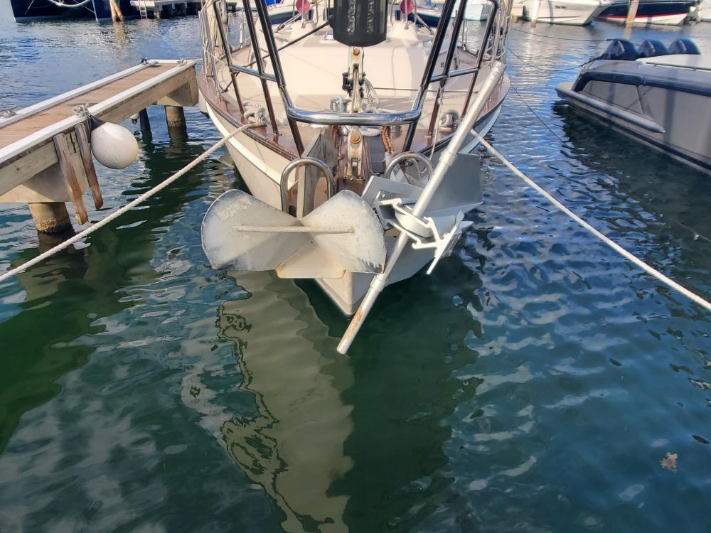 A boat is tied to a dock in the water.