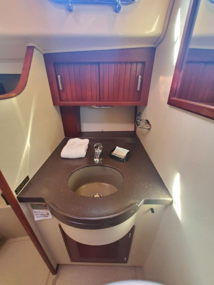 A bathroom on a boat with a sink and a mirror