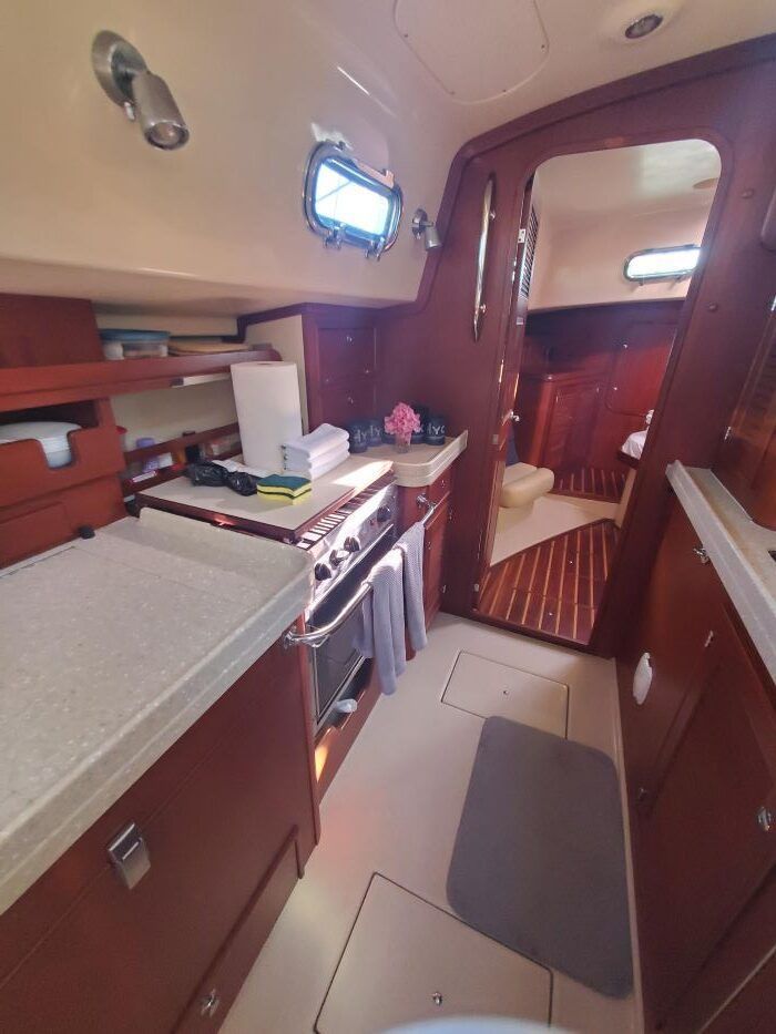 A kitchen on a boat with a stove and a sink