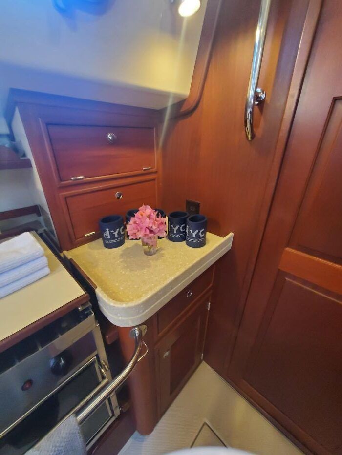 A kitchen on a boat with a counter top and a stove.