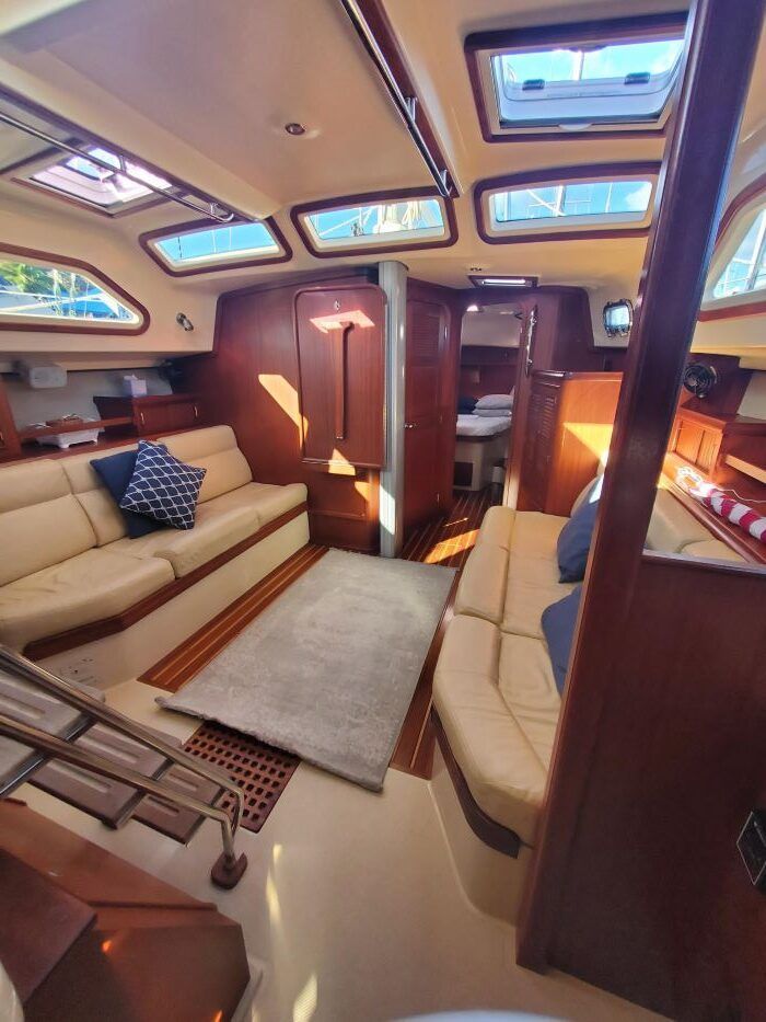 A living room on a boat with a couch and a rug