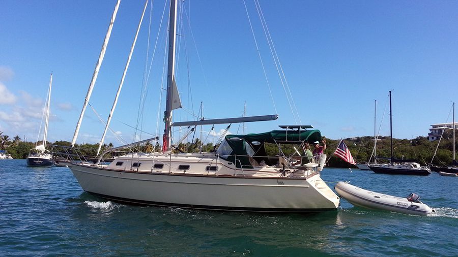 A sailboat is floating on top of a body of water.