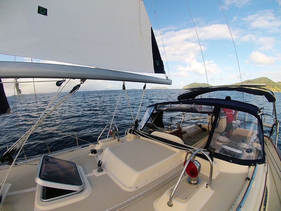 A sailboat is floating on top of a body of water.