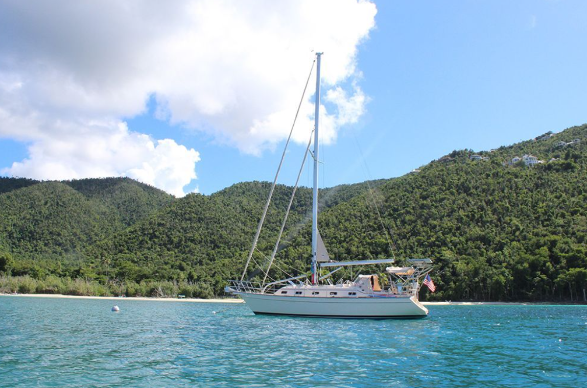 A sailboat is floating on top of a body of water.