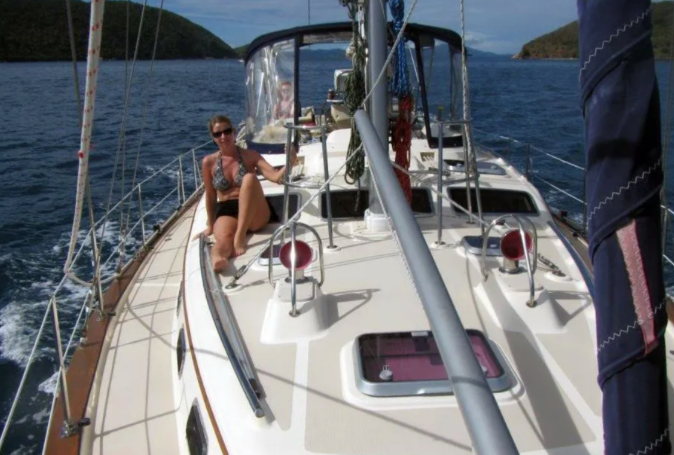 Woman sitting on yacht enjoying the waters