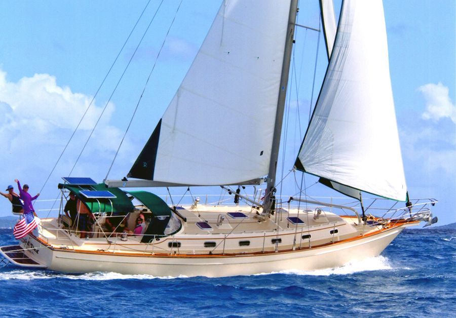 A sailboat is floating on top of a body of water