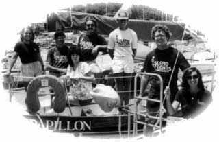 A group of people standing on a boat that says papillon