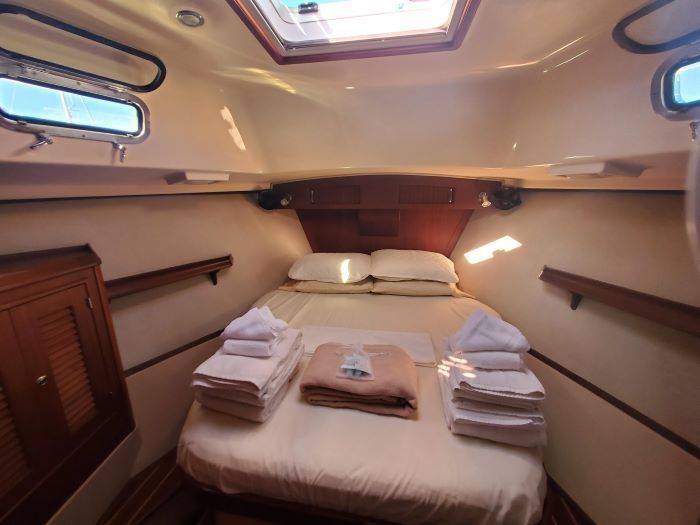 The inside of a boat with a bed and towels