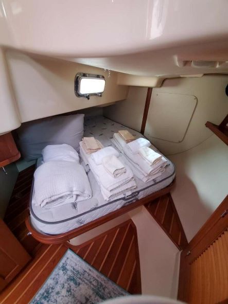 A boat with a bed and pillows on it