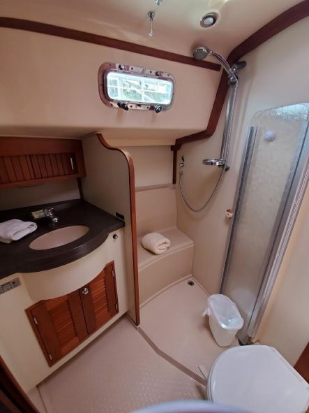 A bathroom on a boat with a sink and toilet