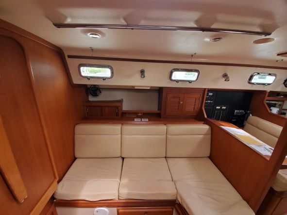 The inside of a boat with a couch and a table