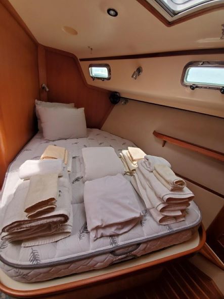 A bedroom on a boat with a mattress and pillows