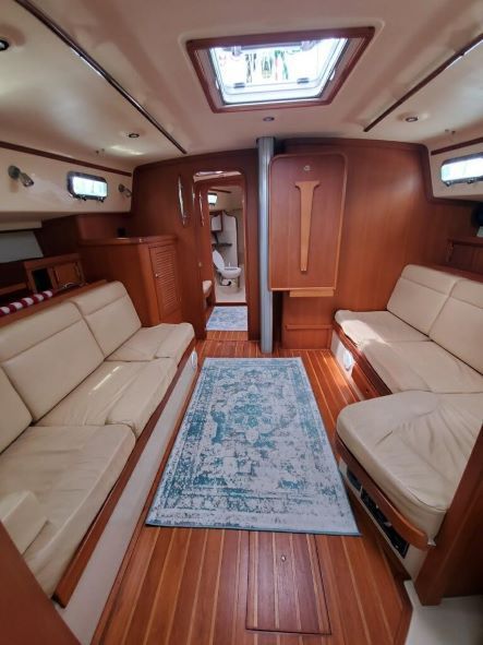 A living room on a boat with two couches and a rug.