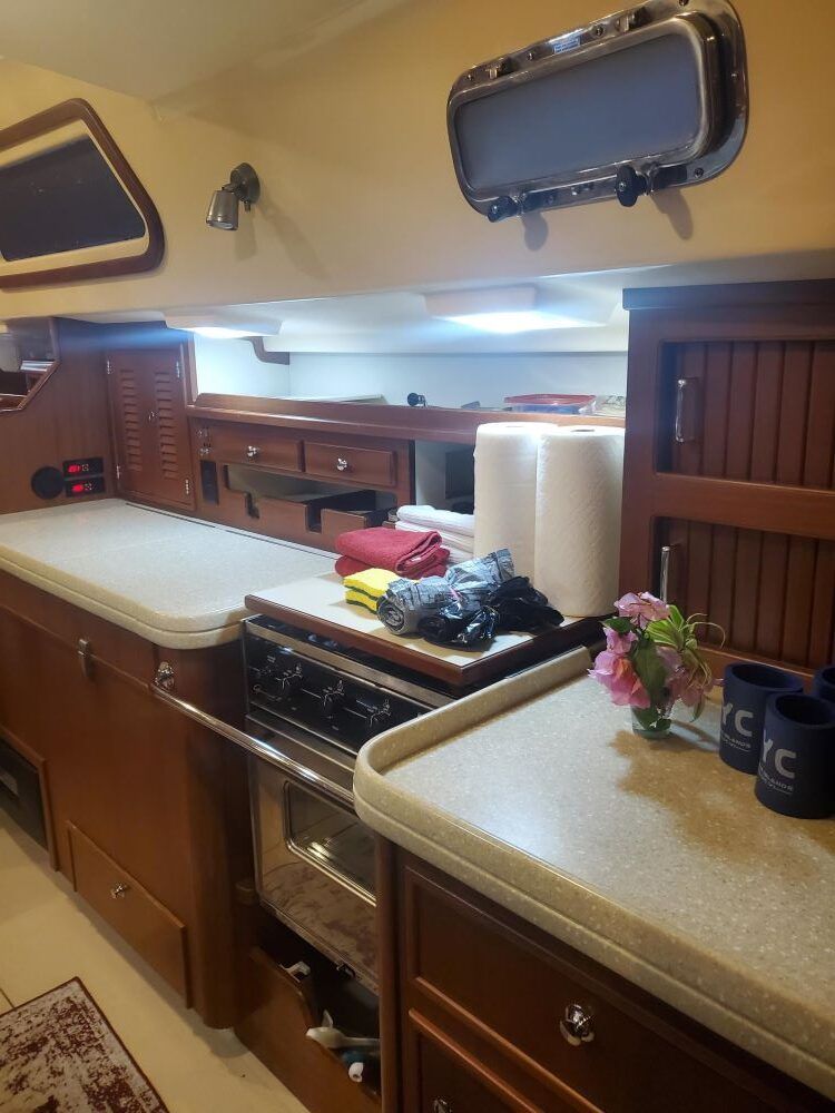A kitchen on a boat with a stove top oven
