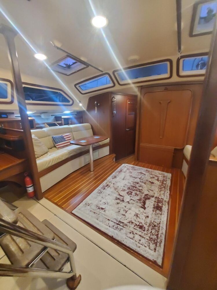 A living room on a boat with a rug and a couch.