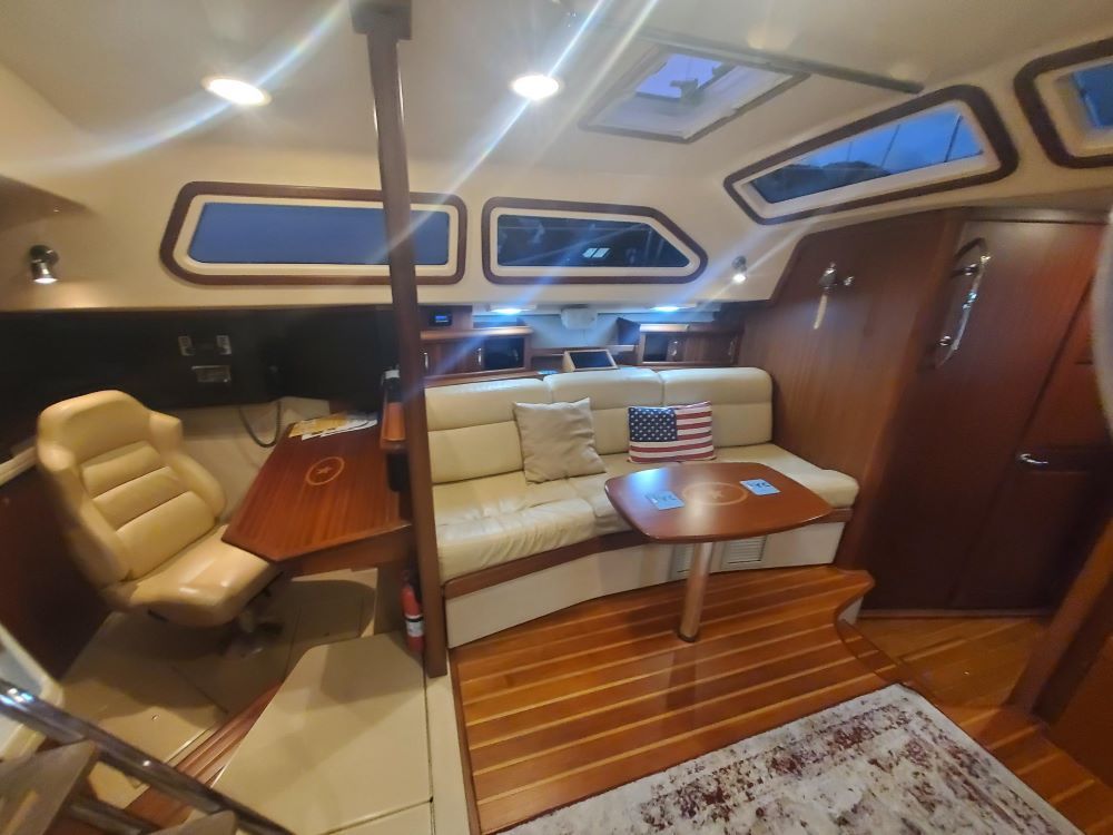 A living room on a boat with a couch and a table