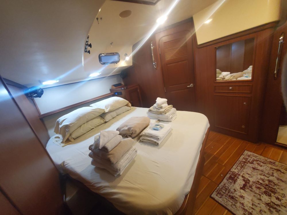 A bedroom with a large bed and towels on it