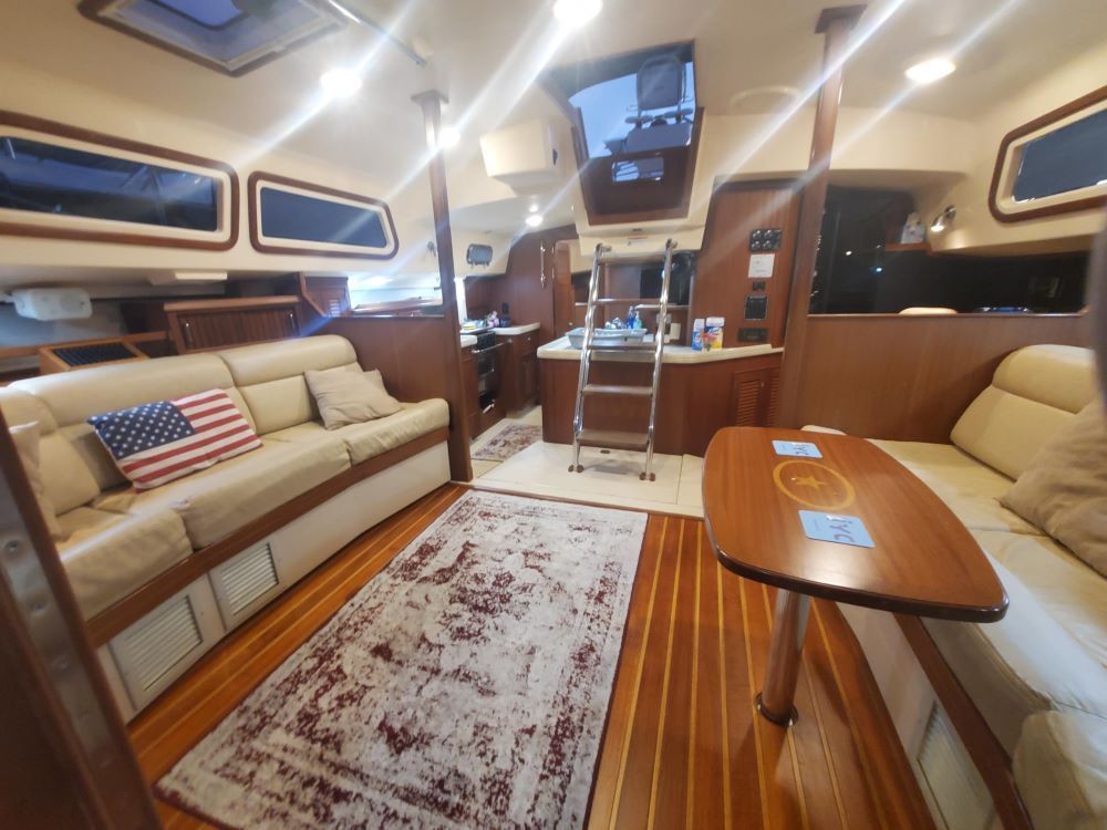 A living room on a boat with a couch and a table