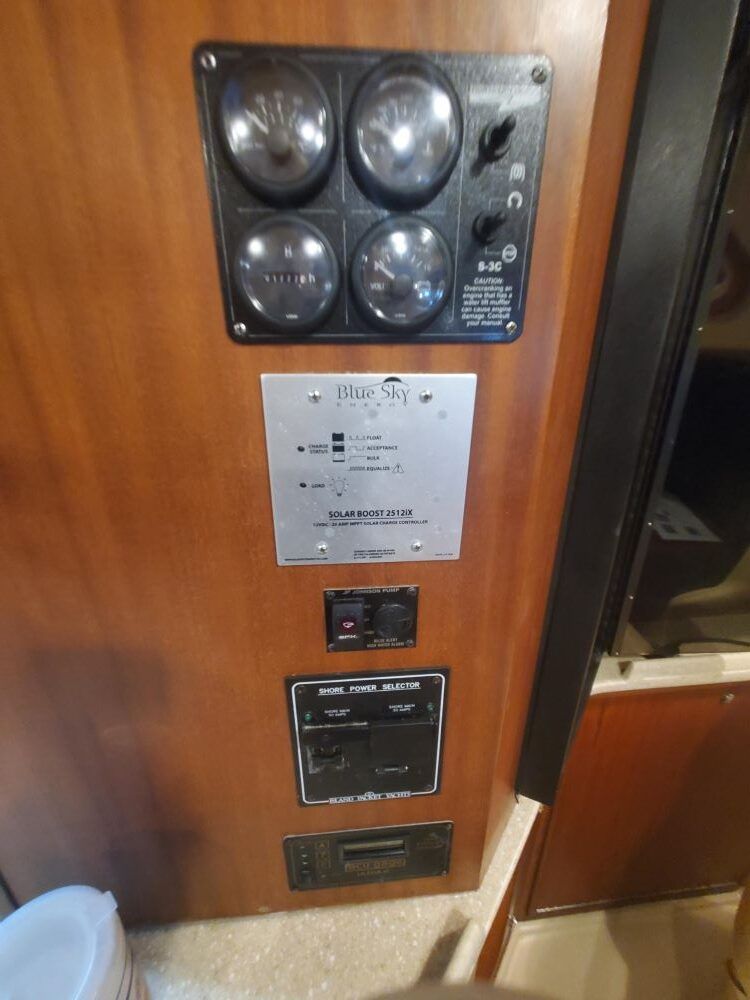 A wooden wall with a bunch of buttons and gauges on it